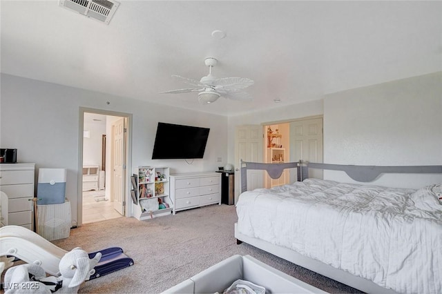 bedroom featuring light colored carpet and ceiling fan