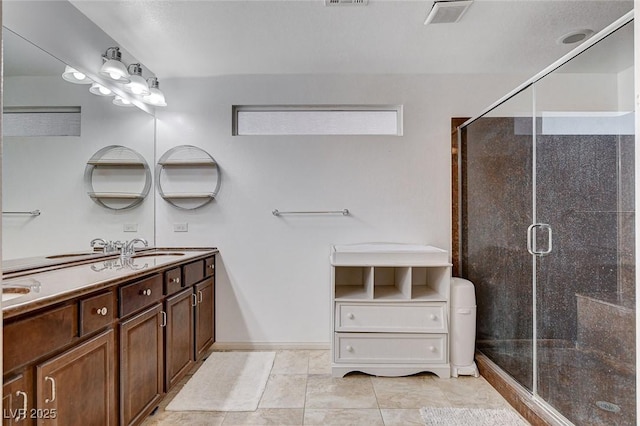 bathroom featuring vanity, tile patterned floors, and a shower with door