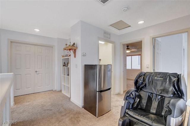 kitchen featuring stainless steel fridge, ceiling fan, and light carpet