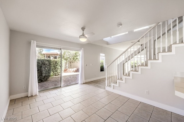 entrance foyer featuring light tile patterned floors and ceiling fan