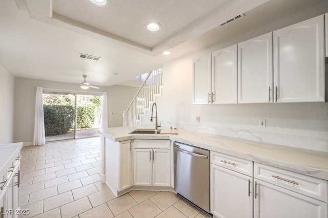 kitchen featuring white cabinetry, dishwasher, ceiling fan, sink, and kitchen peninsula