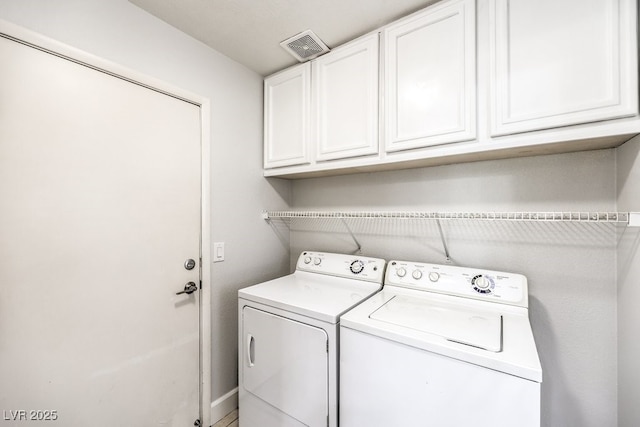 laundry area featuring cabinets and washing machine and clothes dryer