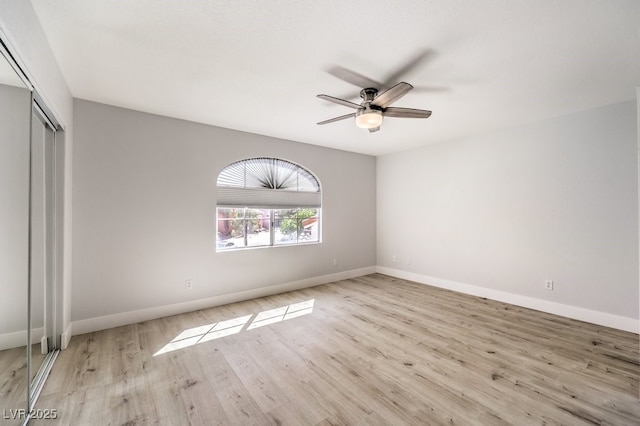 unfurnished bedroom with light wood-type flooring, a closet, and ceiling fan