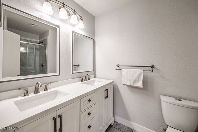 bathroom featuring vanity, toilet, and an enclosed shower