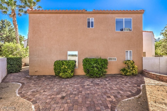 view of side of property featuring a patio