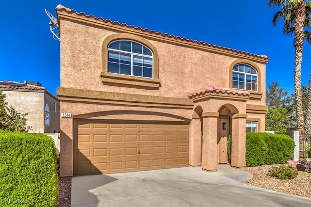 mediterranean / spanish-style house featuring a garage