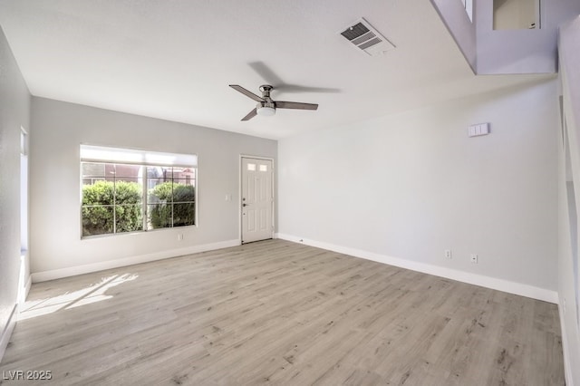 empty room with light hardwood / wood-style flooring and ceiling fan