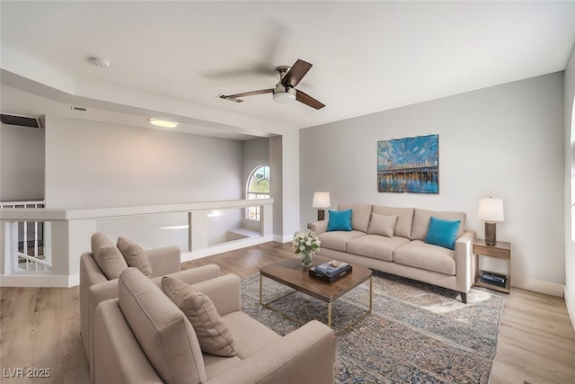 living room featuring ceiling fan and light wood-type flooring