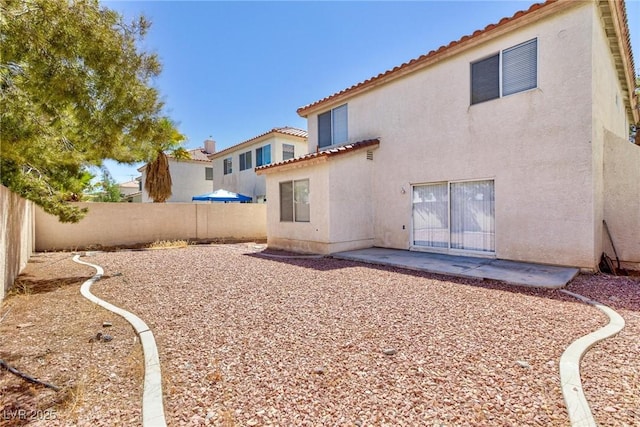 back of house with a patio