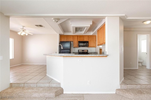 kitchen with kitchen peninsula, light tile patterned floors, ceiling fan, and black appliances