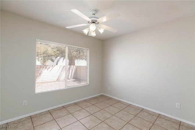 unfurnished room with ceiling fan and light tile patterned floors