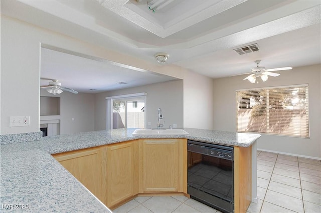 kitchen featuring dishwasher, sink, kitchen peninsula, light brown cabinetry, and light tile patterned flooring