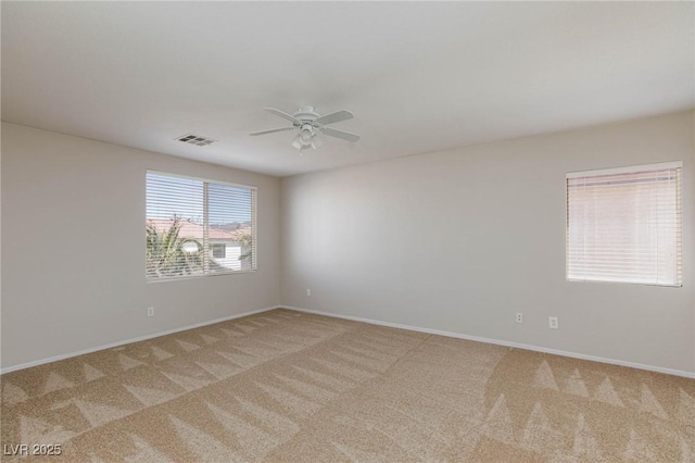 unfurnished room featuring light carpet and ceiling fan