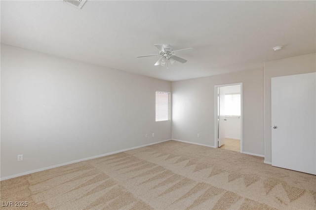 unfurnished room featuring light carpet and ceiling fan