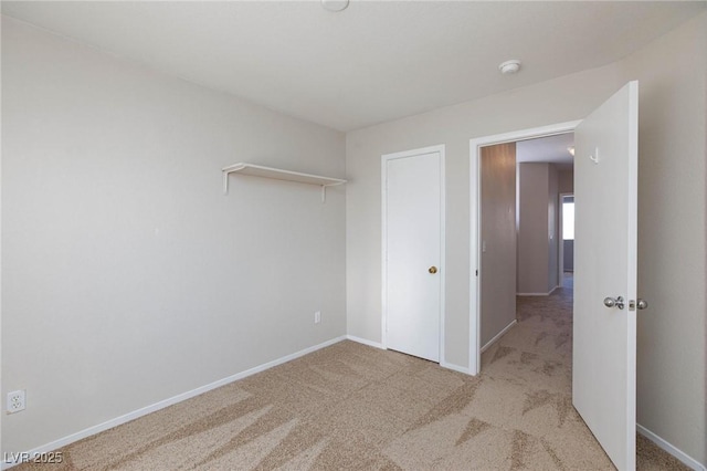 unfurnished bedroom featuring light carpet