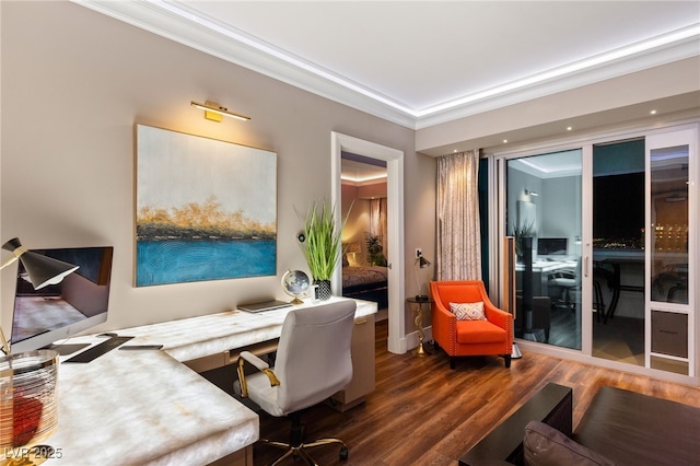 office space with dark hardwood / wood-style flooring, built in desk, and crown molding