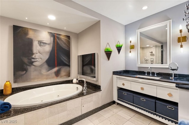 bathroom featuring vanity, tile patterned flooring, and a relaxing tiled tub