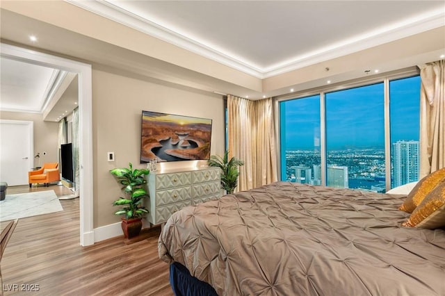 bedroom featuring wood-type flooring and ornamental molding