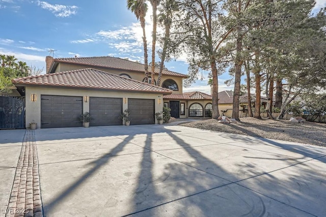 mediterranean / spanish house with a garage