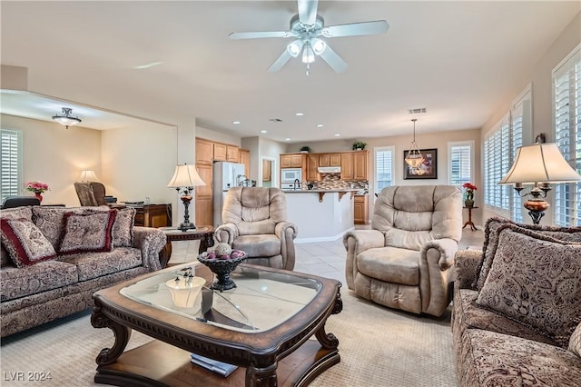 tiled living room with ceiling fan