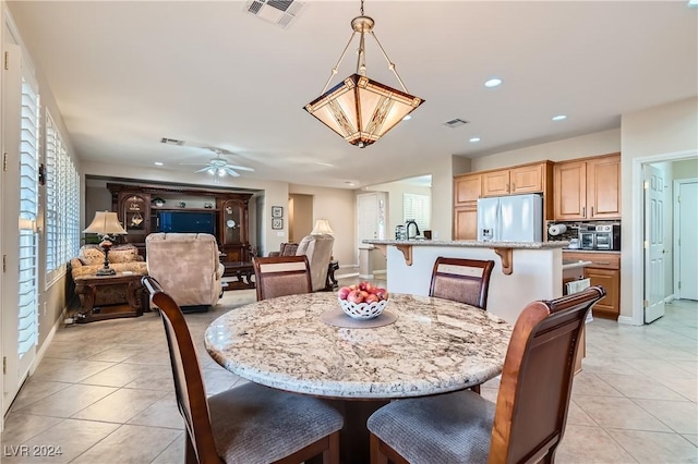 dining area featuring ceiling fan and light tile patterned floors