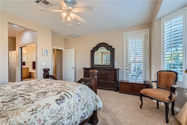 carpeted bedroom with ensuite bathroom and ceiling fan