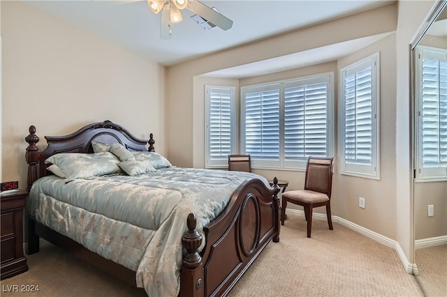 bedroom featuring light carpet and ceiling fan