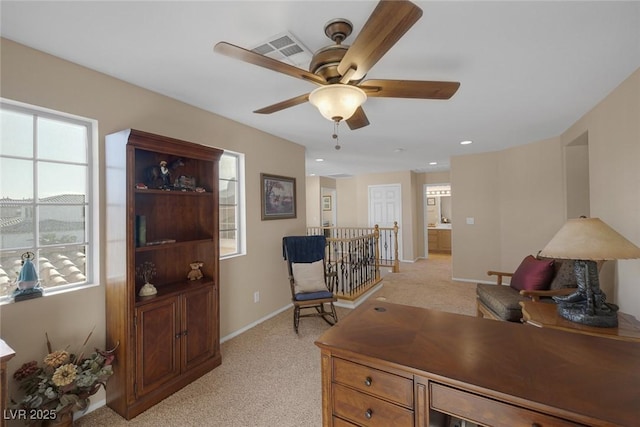 office featuring ceiling fan and light carpet