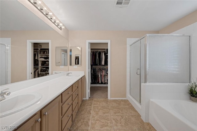 bathroom featuring vanity and shower with separate bathtub