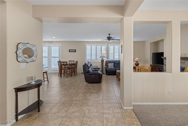 tiled living room featuring ceiling fan