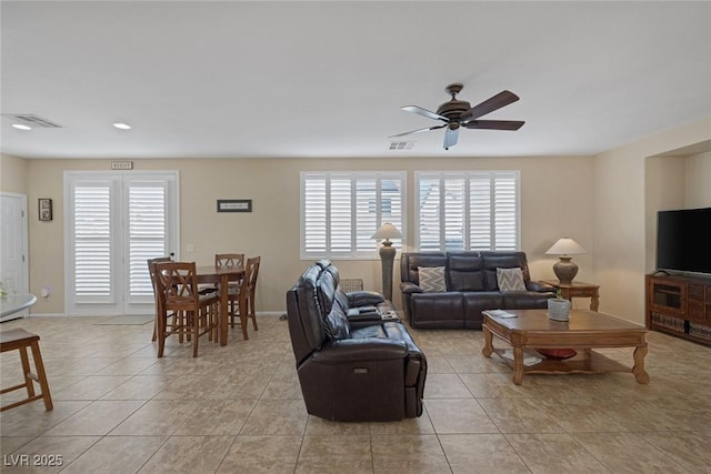 tiled living room with ceiling fan and plenty of natural light