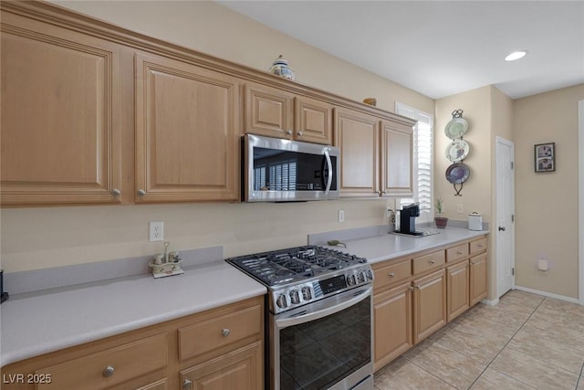 kitchen with appliances with stainless steel finishes and light tile patterned flooring