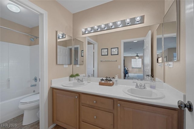 full bathroom featuring ceiling fan, toilet, shower / tub combination, and vanity