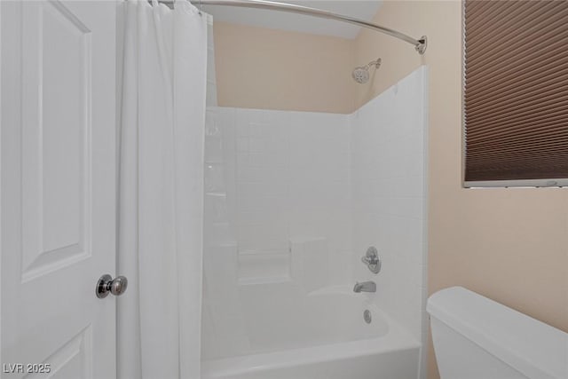 bathroom featuring shower / bathtub combination with curtain and toilet