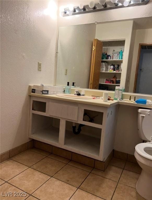 bathroom with tile patterned floors, toilet, and sink