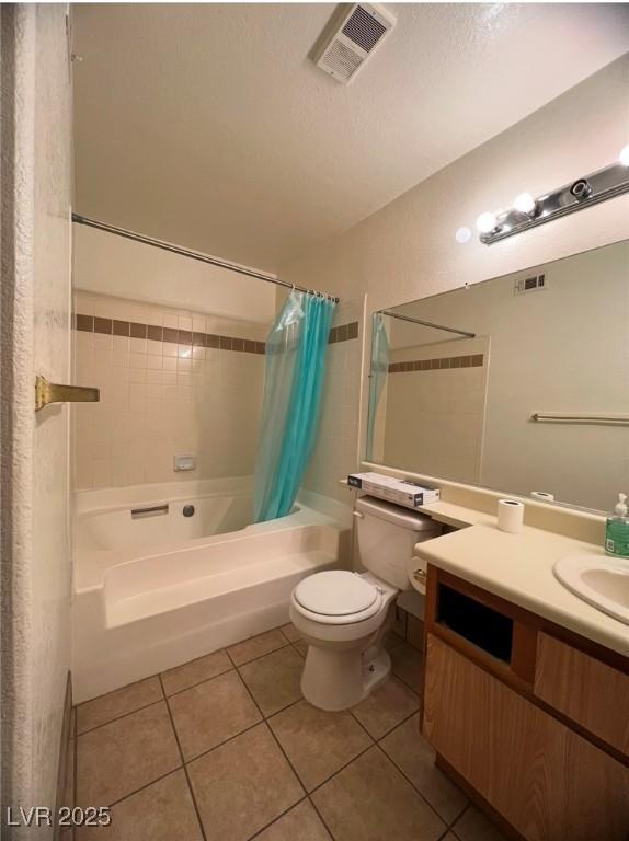 full bathroom with shower / bath combo, vanity, a textured ceiling, tile patterned flooring, and toilet