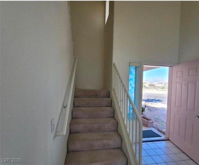 staircase featuring tile patterned floors