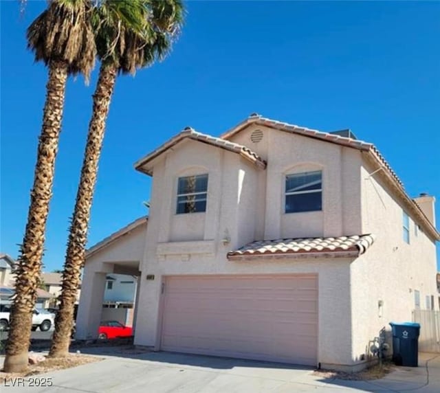 mediterranean / spanish-style home with a garage