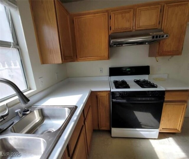 kitchen featuring white gas range and sink