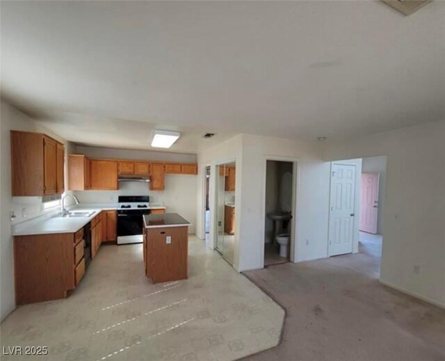 kitchen with a center island, sink, white stove, and light carpet