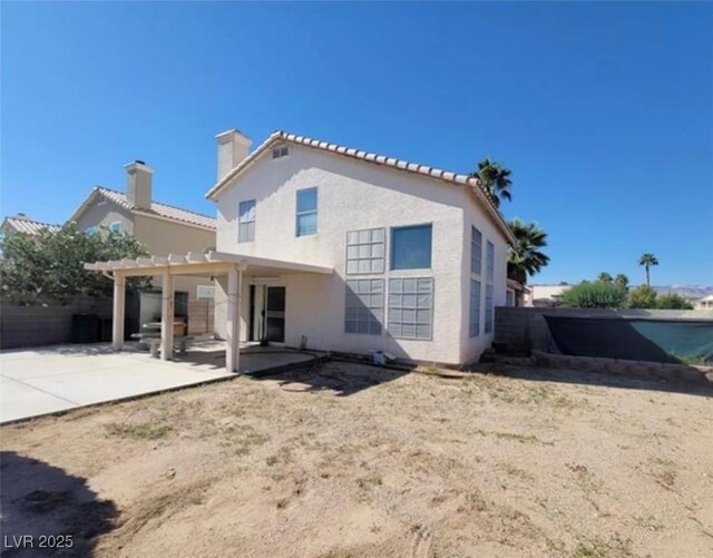 back of house with a patio and a pergola