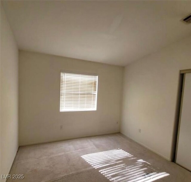 empty room featuring light colored carpet