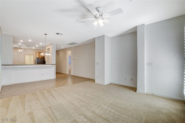 unfurnished living room with ceiling fan and light tile patterned flooring