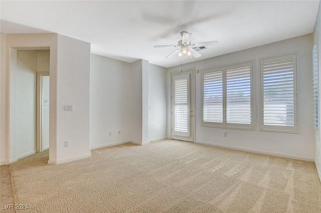 carpeted empty room featuring ceiling fan