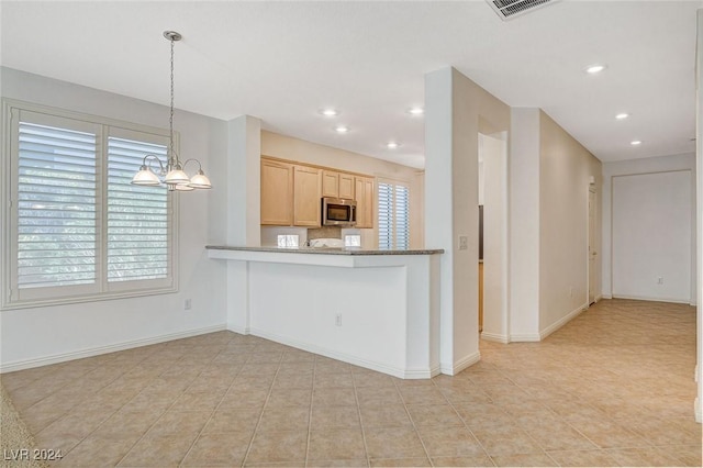 kitchen featuring pendant lighting, an inviting chandelier, light tile patterned floors, light brown cabinetry, and kitchen peninsula