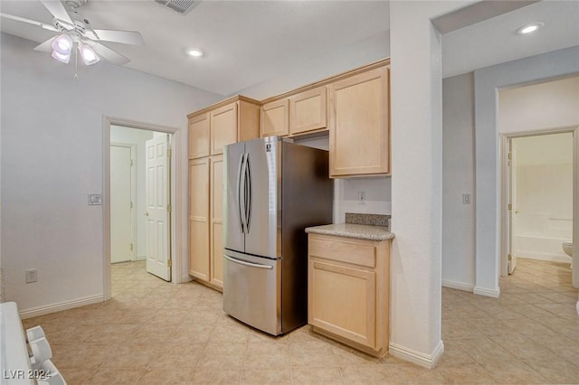 kitchen featuring light brown cabinets, stainless steel refrigerator, and ceiling fan