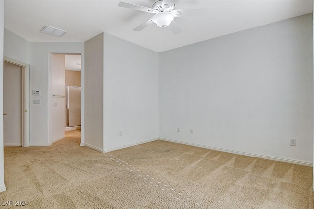 carpeted empty room featuring ceiling fan