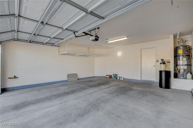 garage with strapped water heater and a garage door opener