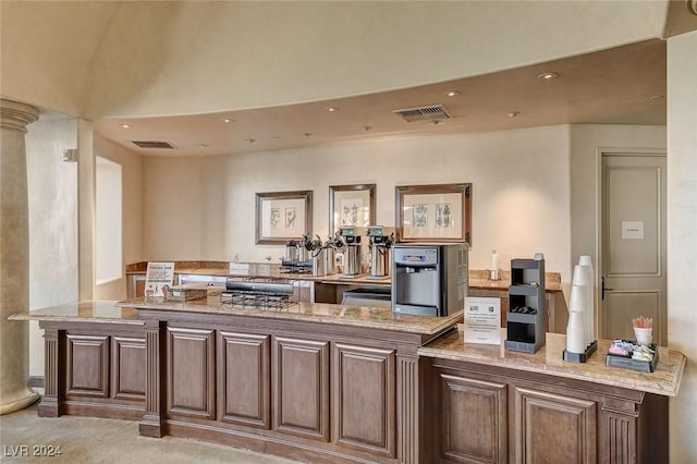 kitchen with light stone countertops and light colored carpet