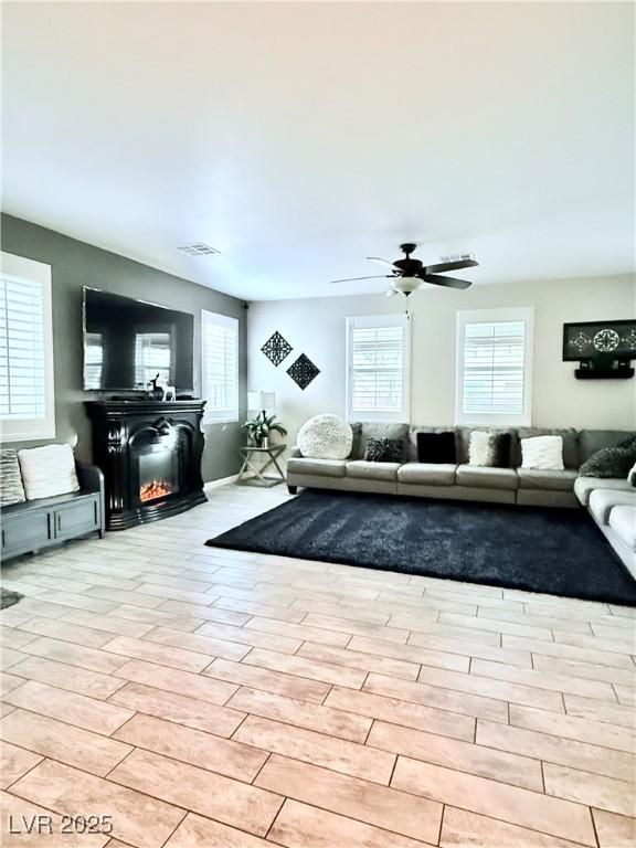 living room with ceiling fan and plenty of natural light